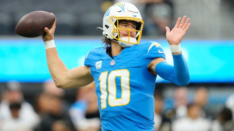 Los Angeles Chargers quarterback Justin Herbert warms up before an NFL football game against the Las Vegas Raiders last season. (Ashley Landis/AP)