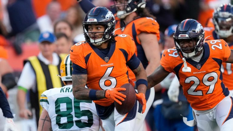 Denver Broncos safety P.J. Locke (6) is congratulated by cornerback Ja'Quan McMillian (29) after intercepting a pass against the Green Bay Packers. (David Zalubowski/AP)