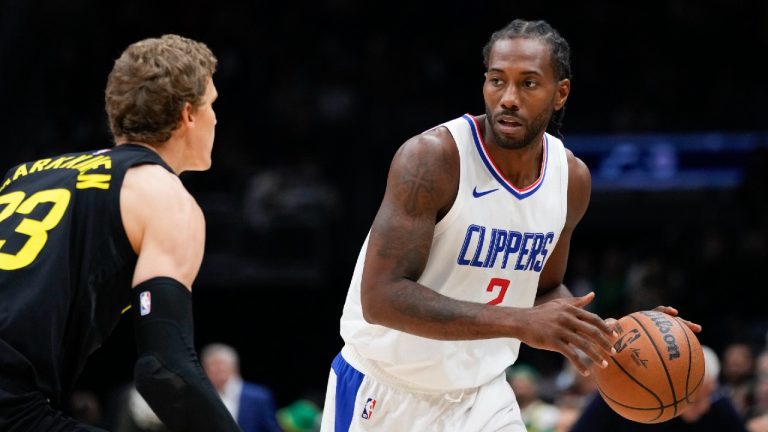 Los Angeles Clippers forward Kawhi Leonard, right, looks past Utah Jazz forward Lauri Markkanen during the first half of a preseason NBA basketball game Tuesday, Oct. 10, 2023, in Seattle. (Lindsey Wasson/AP)