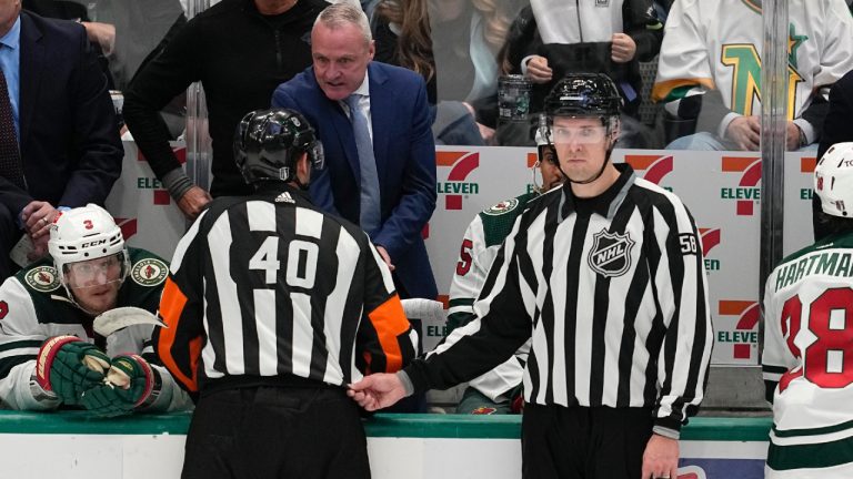 Minnesota Wild head coach Dean Evason, centre in blue coat, talks to referee Steve Kozari (40) and linesman Ryan Gibbons (58) late in the third period of Game 5 of an NHL hockey Stanley Cup first-round playoff series against the Dallas Stars, Tuesday, April 25, 2023, in Dallas. (Tony Gutierrez/AP)