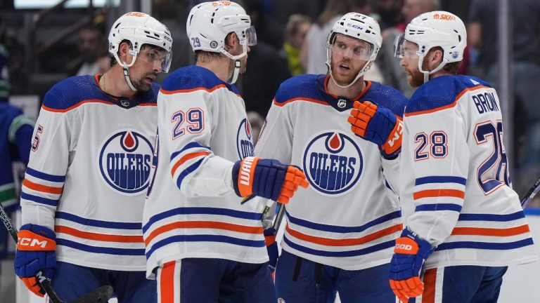 Edmonton Oilers' Connor McDavid, third left, speaks to Leon Draisaitl (29), Cody Ceci (5) and Connor Brown (28) during the third period of an NHL hockey game against the Vancouver Canucks in Vancouver, on Wednesday, October 11, 2023. (Darryl Dyck/CP)