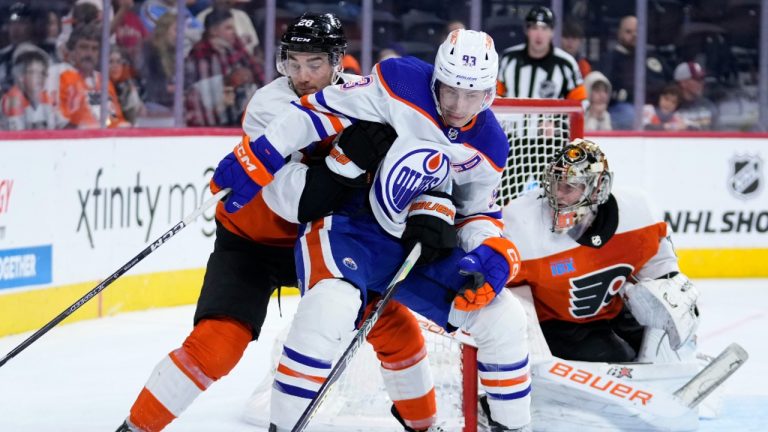 Philadelphia Flyers' Sean Walker, left, and Edmonton Oilers' Ryan Nugent-Hopkins collide during the third period of an NHL hockey game. (Matt Slocum/AP)