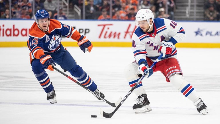 New York Rangers' Artemi Panarin (10) and Edmonton Oilers' Mattias Janmark (13) battle for the puck during first period NHL action in Edmonton, Thursday, Oct. 26, 2023. (Jason Franson/CP)