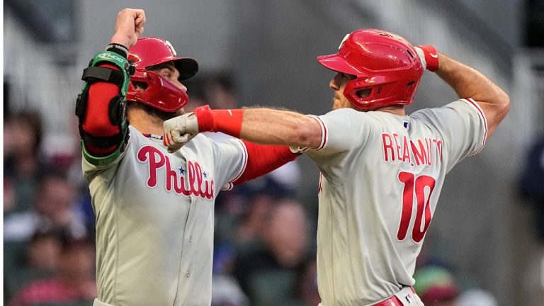 Philadelphia Phillies' J.T. Realmuto celebrates his two-run homer with Bryce Harper in the third inning of Game 2 of a baseball NL Division Series against the Atlanta Braves, Monday, Oct. 9, 2023, in Atlanta. (Brynn Anderson/AP Photo)