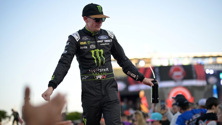 Riley Herbst slaps hands with spectators during driver introductions before a NASCAR Cup Series auto race at Daytona International Speedway, Saturday, Aug. 26, 2023, in Daytona Beach, Fla. (Phelan M. Ebenhack/AP)