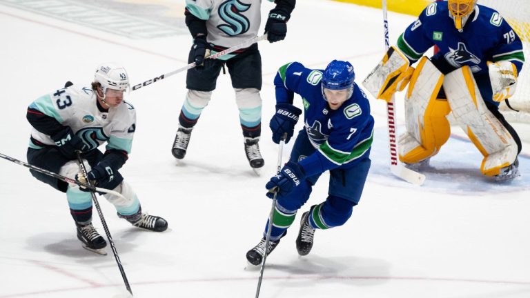 Vancouver Canucks' Carson Soucy (7) skates with the puck as Seattle Kraken's Marian Studenic defends during the first period of an NHL preseason game in Abbotsford, B.C. on Wednesday, Oct. 4, 2023. (Ethan Cairns/CP Photo)