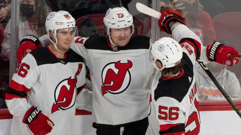 New Jersey Devils' Tyler Toffoli celebrates his empty net goal for a hat trick with teammates Jack Hughes and Erik Haula during third period NHL hockey action against the Montreal Canadiens in Montreal on Tuesday, Oct. 24, 2023. (Christinne Muschi/CP Photo)