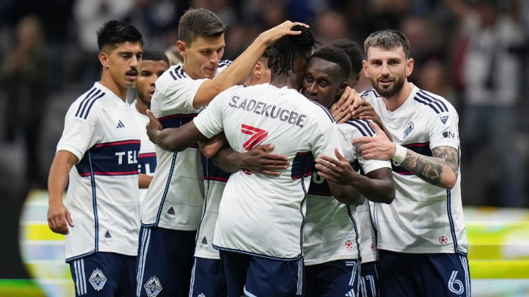 Vancouver Whitecaps' Richie Laryea (7), Sam Adekugbe (3), Tristan Blackmon (6) and Ranko Veselinovic, second left, celebrate Laryea's goal against St. Louis City during the second half of an MLS soccer match in Vancouver, on Wednesday, October 4, 2023. (Darryl Dyck/CP)