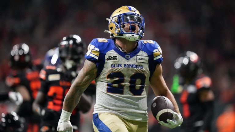 Winnipeg Blue Bombers' Brady Oliveira celebrates his rushing touchdown against the B.C. Lions during overtime CFL football action, in Vancouver, on Friday, October 6, 2023. (Darryl Dyck/CP)