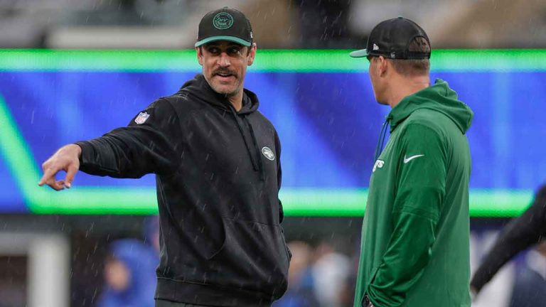 New York Jets quarterback Aaron Rodgers, left, and quarterback Zach Wilson, right, attend practice in the rain before an NFL football game against the New York Giants. (Adam Hunger/AP)