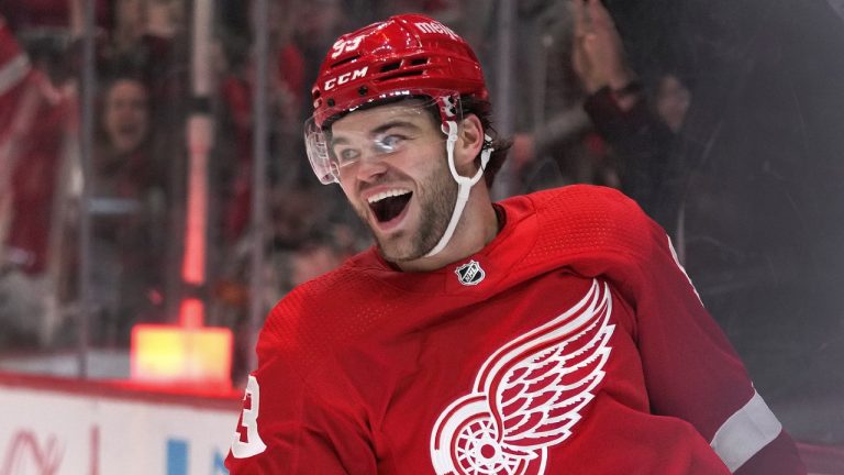 Detroit right-wing Alex DeBrincat smiles after his goal against the Calgary Flames in the third period of an NHL hockey game, in Detroit, Sunday, Oct. 22, 2023. (Paul Sancya/AP)