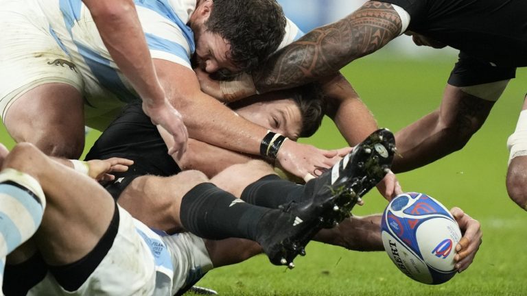 New Zealand's Beauden Barrett, centre, tries to hold on to the ball during the Rugby World Cup semifinal match between Argentina and New Zealand at the Stade de France in Saint-Denis, outside Paris, Friday, 20, 2023. (Pavel Golovkin/AP)