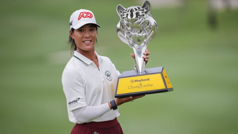 Celine Boutier of France celebrates with the winner's trophy after winning the final round of the LPGA Maybank Championship in Kuala Lumpur, Malaysia, Sunday, Oct. 29, 2023. (Vincent Thian/AP)