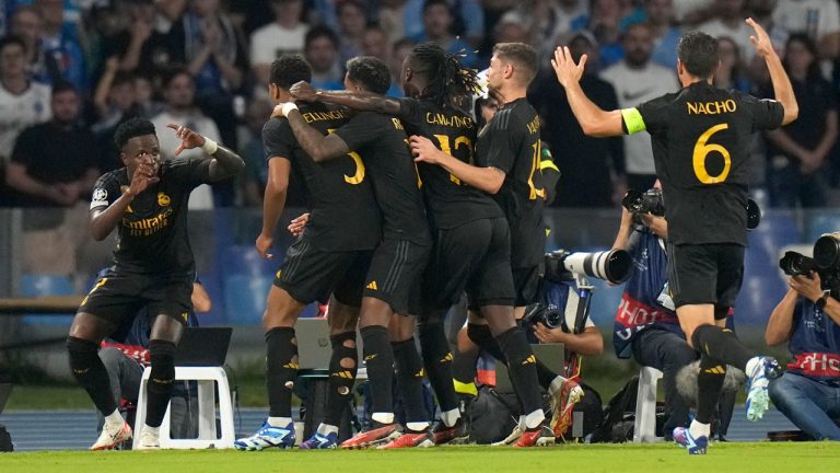 Real Madrid's Jude Bellingham celebrates with teammates after scoring his sides second goal during the Champions League group C soccer match between Napoli and Real Madrid at the Diego Armando Maradona stadium in Naples, Italy. (Alessandra Tarantino/AP)