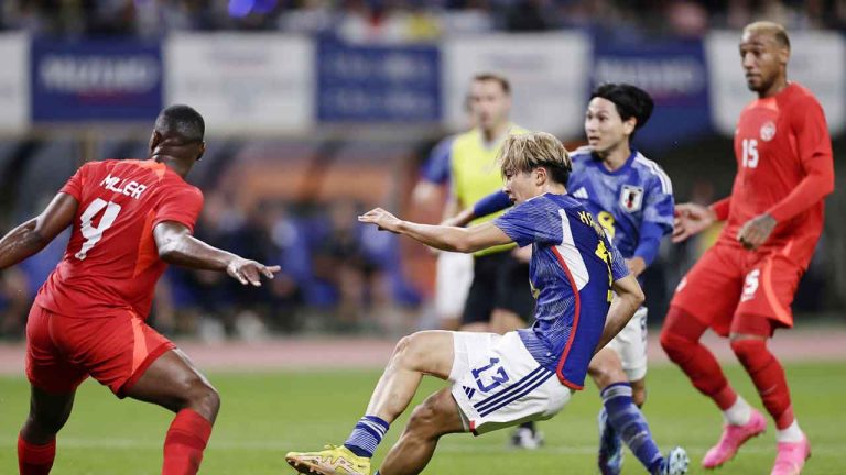 Keito Nakamura, center, of Japan, scores a goal past Kamal Miller, left, of Canada during a friendly soccer match in Niigata. (Kyodo News/AP)