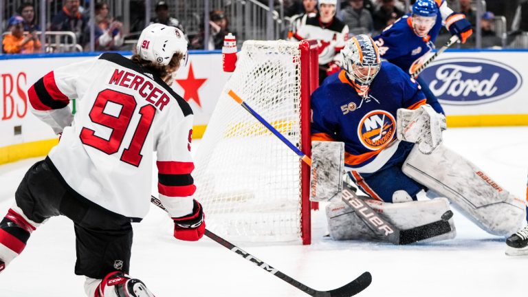 New York Islanders goaltender Ilya Sorokin (30) stops a shot on goal by New Jersey Devils' Dawson Mercer (91) during the first period of an NHL hockey game Monday, March 27, 2023, in Elmont, N.Y. (Frank Franklin II/AP)