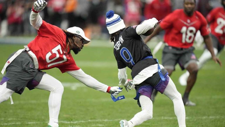 AFC middle linebacker C.J. Mosley of the New York Jets, left, grabs a flag off NFC return specialist KaVontae Turpin (9) of the Dallas Cowboys during the flag football event at the NFL Pro Bowl, Sunday, Feb. 5, 2023, in Las Vegas. The International Olympic Committee has included flag football in the official program for the 2028 Games slated for Los Angeles. (John Locher/AP)