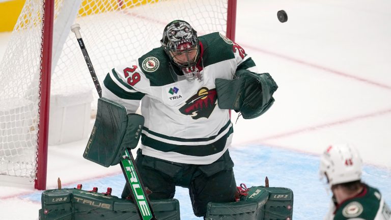 Minnesota Wild goaltender Marc-Andre Fleury (29) deflects a high shot to the net as defenceman Ryan O'Rourke (45) looks on in the first period of a preseason NHL hockey game, Tuesday, Sept. 26, 2023, in Dallas. (Tony Gutierrez/AP)