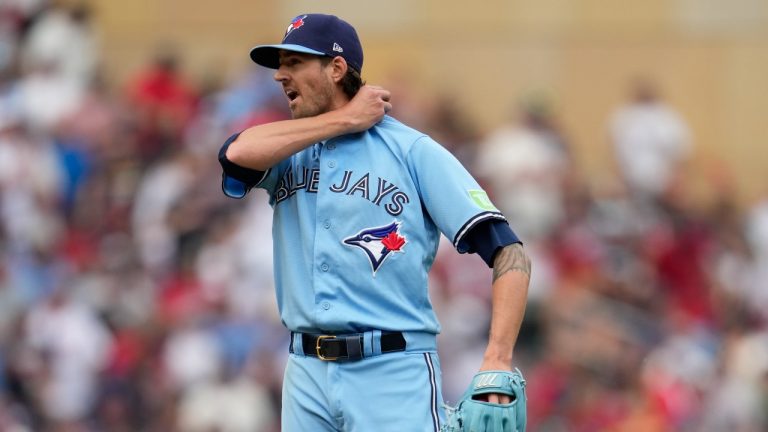 Toronto Blue Jays starting pitcher Kevin Gausman walks off the mound after giving up a single to Minnesota Twins' Michael A. Taylor during the second inning in Game 1 of an AL wild-card baseball playoff series Tuesday, Oct. 3, 2023, in Minneapolis. (Abbie Parr/AP Photo)