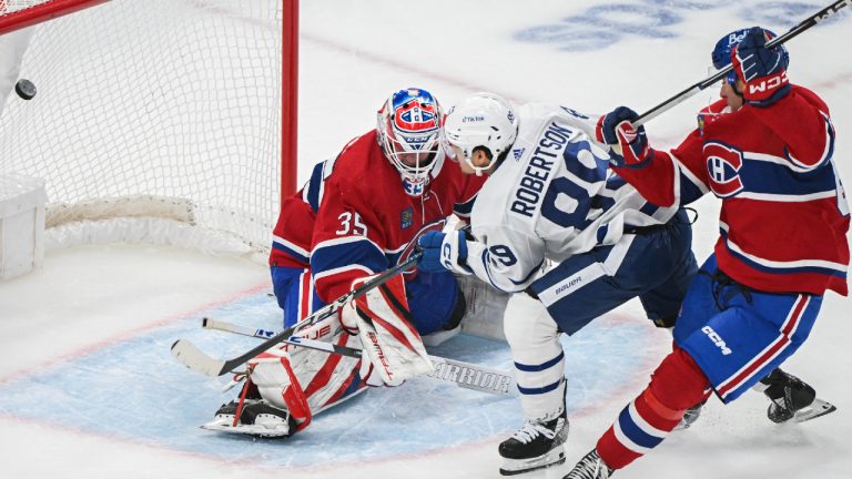 Toronto Maple Leafs' Nicholas Robertson (89) scores against Montreal Canadiens goaltender Samuel Montembeault as Canadiens' William Trudeau defends during second period NHL preseason hockey action in Montreal, Saturday, Sept. 30, 2023. (Graham Hughes/CP)