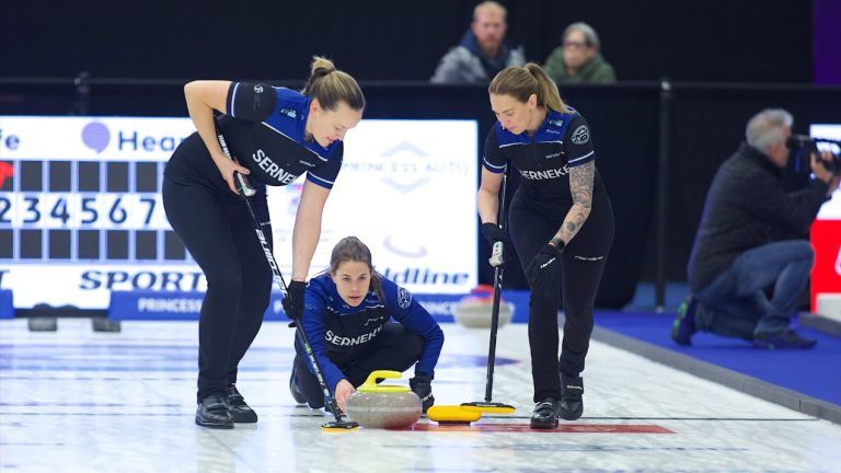 Anna Hasselborg (centre)  releases a rock as Agnes Knochenhauer (left) and Sofia Mabergs (right) prepare to sweep during the sixth draw of the HearingLife Tour Challenge on Wednesday, Oct. 18, 2023, in Niagara Falls, Ont. (Anil Mungal/GSOC)