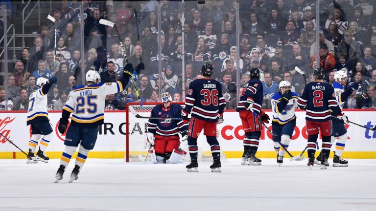 St. Louis Blues' Pavel Buchnevich (right) celebrates his goal on Winnipeg Jets goaltender Connor Hellebuyck (37) during the second period of NHL action in Winnipeg on Tuesday October 24, 2023. The Jets have already set a record this season, but it’s nothing to cheer about. (Fred Greenslade/CP)