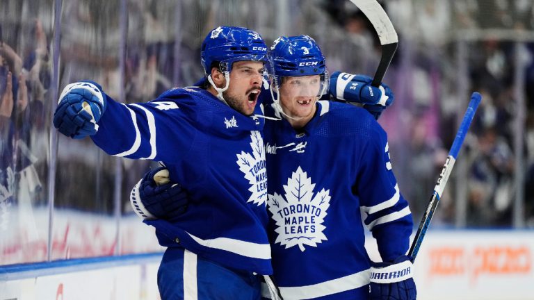 Toronto Maple Leafs' Auston Matthews (34) celebrates his goal against the Montreal Canadiens with John Klingberg (3) during second period NHL hockey action in Toronto on Wednesday, October 11, 2023. (Frank Gunn/CP)