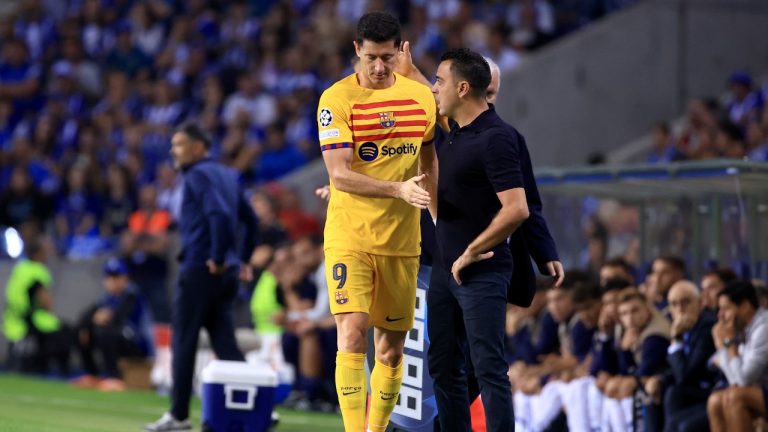 Barcelona's Robert Lewandowski walks past Barcelona's head coach Xavi Hernandez after being substituted due to an injury during a Champions League group H soccer match between FC Porto and Barcelona at the Dragao stadium in Porto, Portugal, Wednesday, Oct. 4, 2023. (Luis Vieira/AP)