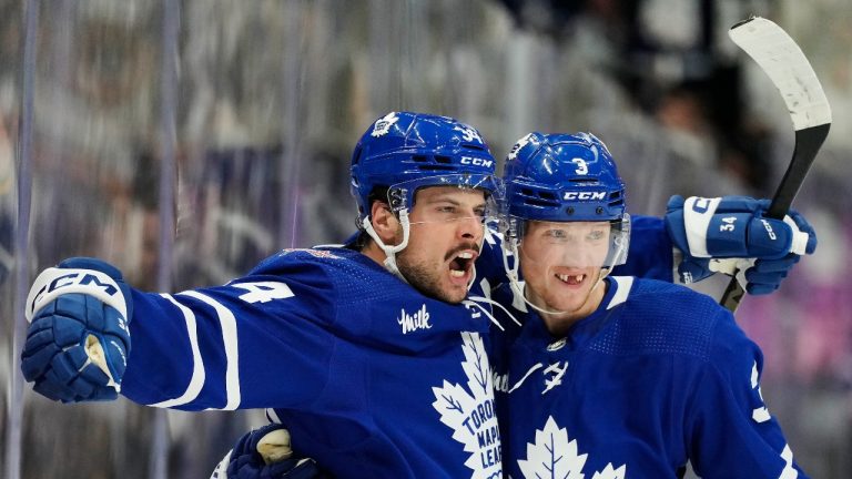 Toronto Maple Leafs' Auston Matthews (34) celebrates his goal against the Montreal Canadiens with John Klingberg (3) during second period NHL hockey action in Toronto on Wednesday, October 11, 2023. (Frank Gunn/THE CANADIAN PRESS)