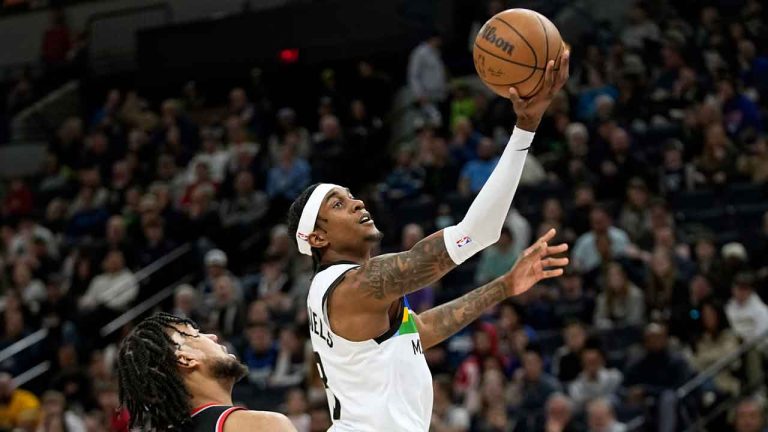 Minnesota Timberwolves forward Jaden McDaniels shoots while defended by Portland Trail Blazers forward Trendon Watford during the first half of an NBA basketball game. (Abbie Parr/AP)