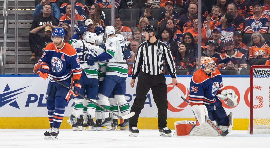 Canucks badly outshot, but still hold off Oilers to start season 20