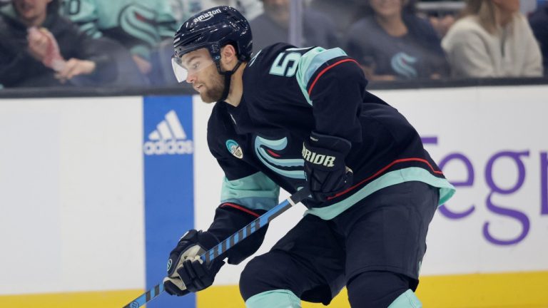 Seattle Kraken forward Shane Wright (51) skates with the puck against the Vancouver Canucks during the first period of a preseason NHL hockey game, Thursday, Sept. 28, 2023, in Seattle. (John Froschauer/AP)