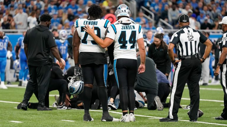 Carolina Panthers long snapper JJ Jansen (44) and Carolina Panthers offensive tackle Ikem Ekwonu (79) comfort each other as guard Chandler Zavala is tended to after being injured in the first half of an NFL football game against the Detroit Lions in Detroit, Sunday, Oct. 8, 2023. (Paul Sancya/AP)