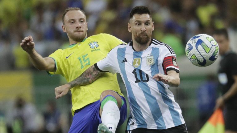 Argentina's Lionel Messi, right, and Brazil's Carlos Augusto battle for the ball during a qualifying soccer match for the FIFA World Cup 2026 at Maracana stadium in Rio de Janeiro, Brazil, Tuesday, Nov. 21, 2023. (Bruna Prado/AP)