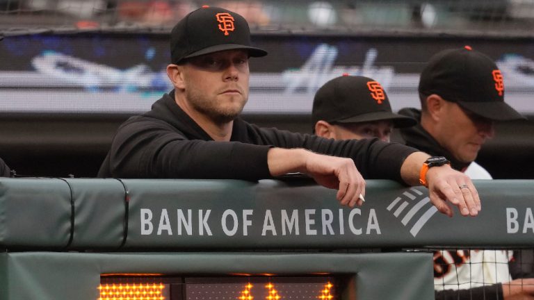 San Francisco Giants pitching coach Andrew Bailey, left, watches from over the pitch clock during a baseball game against the Los Angeles Dodgers in San Francisco, Monday, April 10, 2023. Bailey was hired Tuesday, Nov. 21, as pitching coach of the Boston Red Sox after four seasons in the same role with the Giants.(Jeff Chiu/AP)