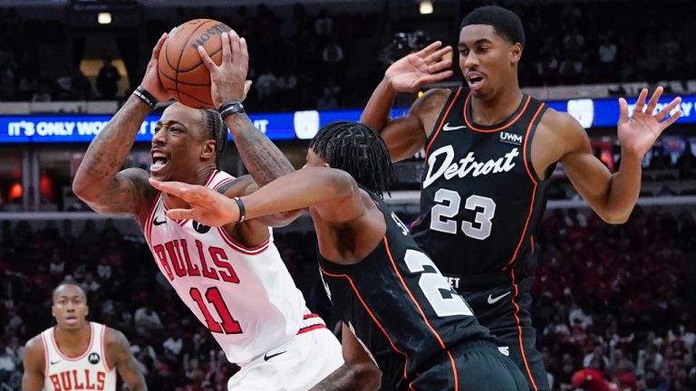 Chicago Bulls forward DeMar DeRozan, left, drives to the basket past Detroit Pistons guard Marcus Sasser and guard Jaden Ivey, right, during the first half of an NBA basketball game in Chicago, Sunday, Nov. 12, 2023. (Nam Y. Huh/AP)