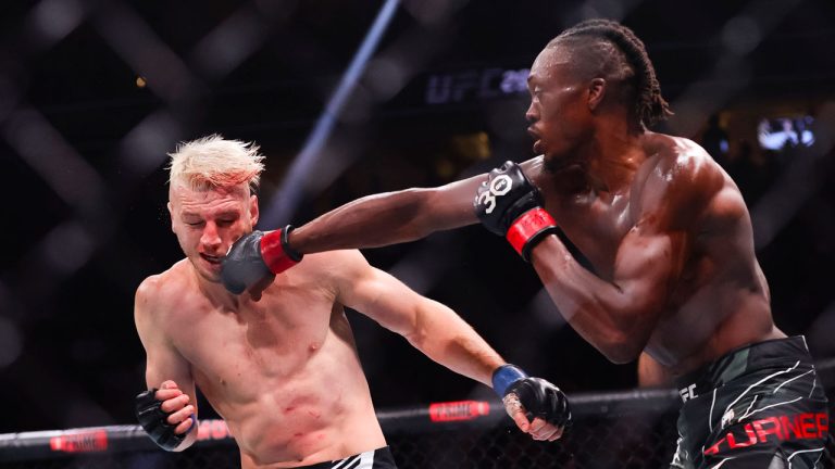 Jalin Turner punches Dan Hooker during a lightweight mixed martial arts bout during UFC 290 on Saturday, July 8, 2023, in Las Vegas. (Wade Vandervort/Las Vegas Sun via AP)