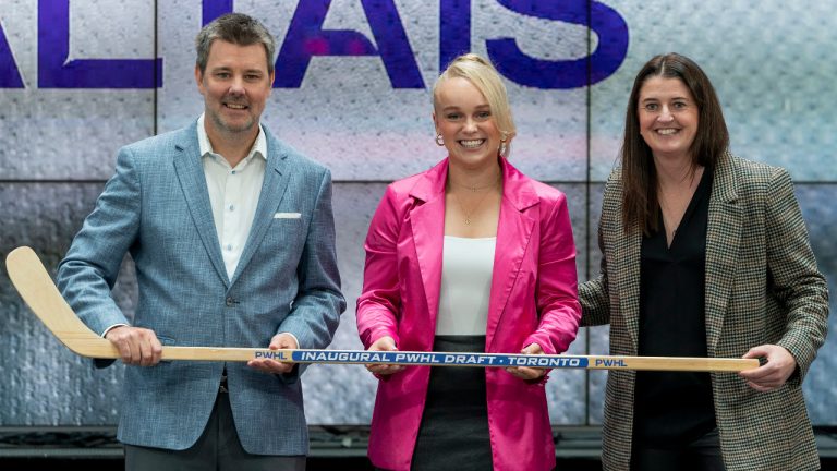 Emma Maltais, centre, from the NCAA, poses for a photo with Toronto general manager Gina Kingsbury, right, and Executive Vice President and President of Canadian Tire Retail, TJ Flood, left, after being selected 11th overall by Toronto during the second round of the inaugural Professional Women’s Hockey League draft in Toronto, on Monday, Sept. 18, 2023. (Spencer Colby/CP)