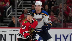 Chicago Blackhawks center Connor Bedard, left and St. Louis Blues defenseman Colton Parayko stand in front of the Blues' net during the second period of a preseason NHL hockey game Thursday, Sept. 28, 2023, in Chicago. (AP Photo/Erin Hooley) 