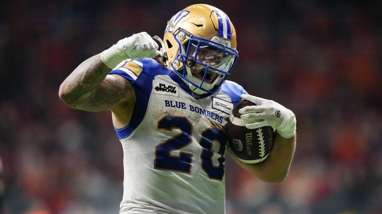 Winnipeg Blue Bombers' Brady Oliveira celebrates his rushing touchdown against the B.C. Lions during overtime CFL football action, in Vancouver, on Friday, October 6, 2023. (Darryl Dyck/CP)