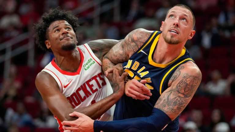 Houston Rockets guard Jalen Green, left, and Indiana Pacers center Daniel Theis watch a free throw during the second half of an NBA preseason basketball game Tuesday, Oct. 10, 2023, in Houston. (AP Photo/Eric Christian Smith)