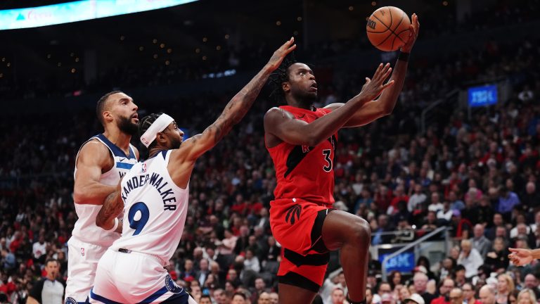 Toronto Raptors' O.G. Anunoby (3) drives as Minnesota Timberwolves' Nickeil Alexander-Walker (9) and Rudy Gobert (left) defend during first half NBA basketball action in Toronto on Wednesday, October 25, 2023. (Nathan Denette/CP)