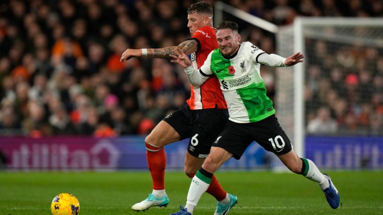 Luton Town's Ross Barkley, left, challenges for the ball with Liverpool's Alexis Mac Allister during the English Premier League soccer match between Luton Town and Liverpool, at Kenilworth Road, in Luton, England, Sunday, Nov. 5, 2023. (Alastair Grant/AP) 