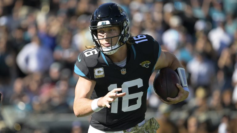 Jacksonville Jaguars quarterback Trevor Lawrence (16) runs out of the pocket during the first half of an NFL football game against the Tennessee Titans, Sunday, Nov. 19, 2023, in Jacksonville, Fla. (Phelan M. Ebenhack/AP)