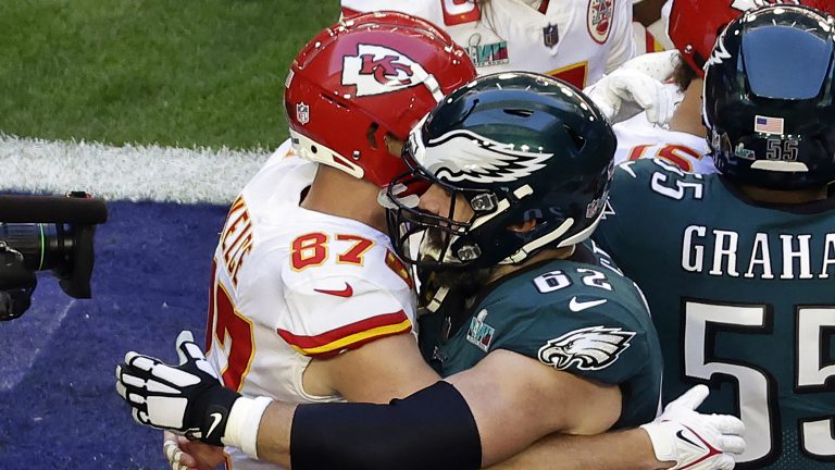 Kansas City Chiefs tight end Travis Kelce (87) embraces his brother Philadelphia Eagles center Jason Kelce (62) before the NFL Super Bowl 57 football game Sunday, Feb. 12, 2023, in Glendale, Ariz. (Adam Hunger/AP)