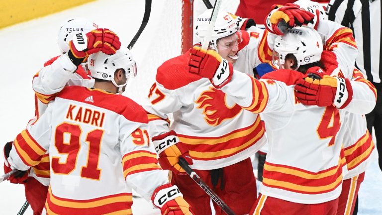 Calgary Flames' Connor Zary (47) celebrates with teammates after scoring against the Montreal Canadiens during second period NHL hockey action in Montreal, Tuesday, November 14, 2023. (Graham Hughes/CP)