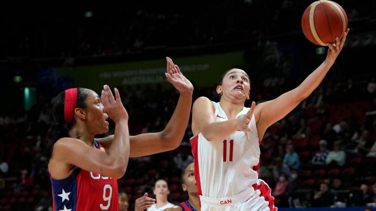 Canada's Natalie Achonwa, right, shoots over United States' A'ja Wilson during their semifinal game at the women's Basketball World Cup in Sydney, Australia, Friday, Sept. 30, 2022. (Rick Rycroft/AP)