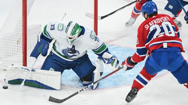 Vancouver Canucks goaltender Casey DeSmith stops Montreal Canadiens' Juraj Slafkovsky during first period NHL hockey action in Montreal, Sunday, November 12, 2023. (Graham Hughes/CP)