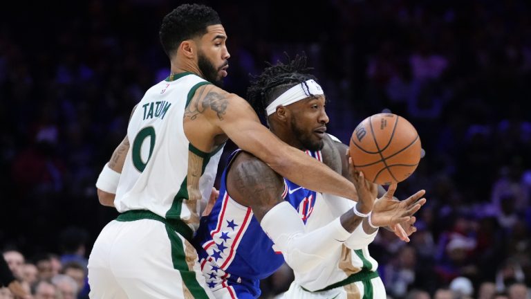 Philadelphia 76ers' Robert Covington, centre, passes against Boston Celtics' Jayson Tatum during the first half of an NBA basketball game, Wednesday, Nov. 15, 2023, in Philadelphia. (Matt Slocum/AP)