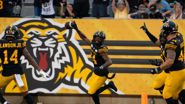 Hamilton Tiger-Cats defensive back Chris Edwards (24) celebrates an interception during first half CFL football game action against the Ottawa Redblacks in Hamilton, Ont. on Saturday, July 8, 2023. (Peter Power/CP)